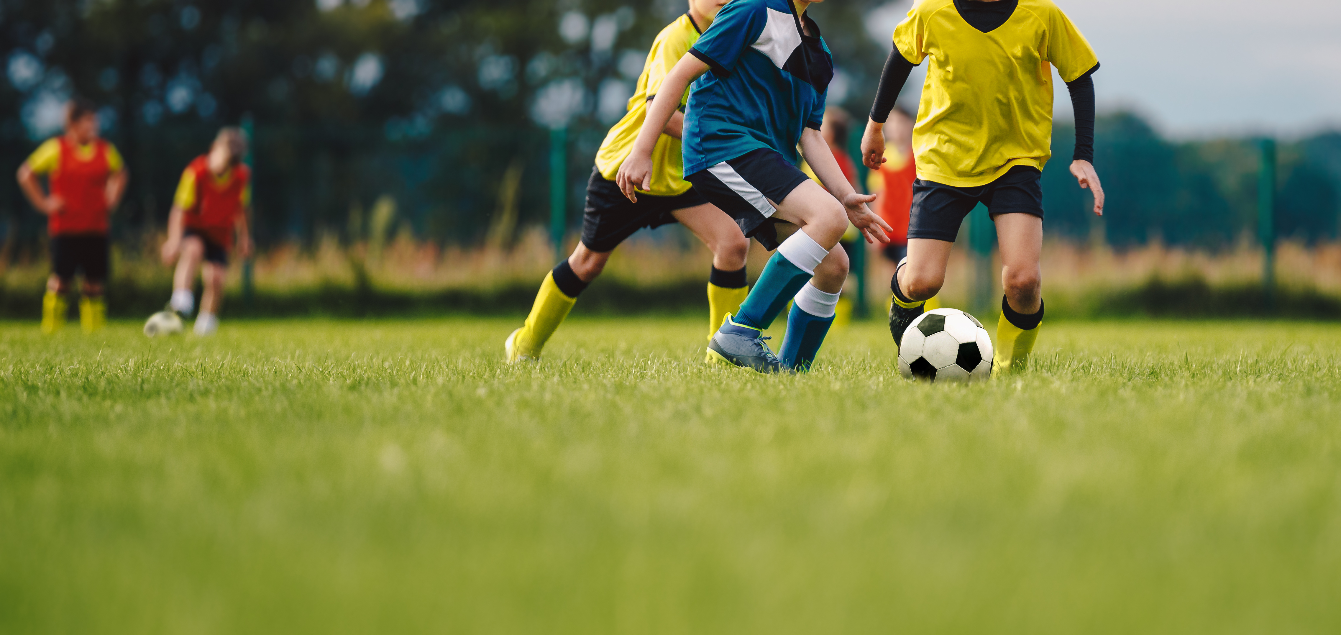 Young boys playing football on a pitch