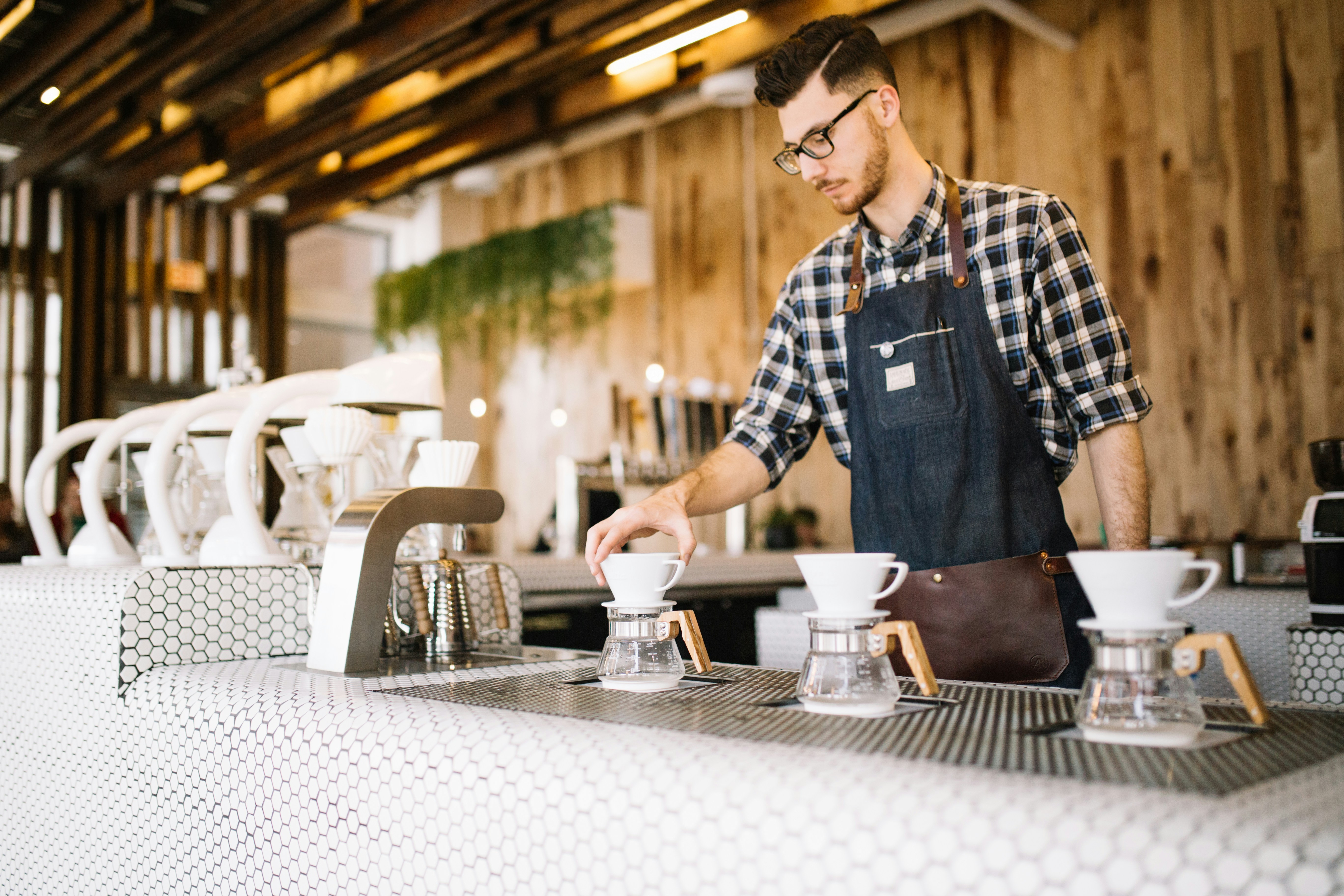 male barista working in a coffee shop