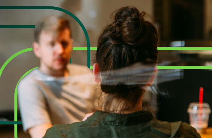 Two colleagues sit facing each other in a meeting, with one person seen from behind and the other slightly out of focus. The setting appears to be an office or advisory environment, with soft lighting and a casual, professional atmosphere. Graphic line elements overlay the image as part of the report’s design.