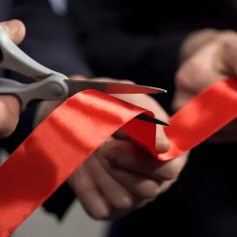 Business people hands cutting red ribbon close-up, new project, opening ceremony