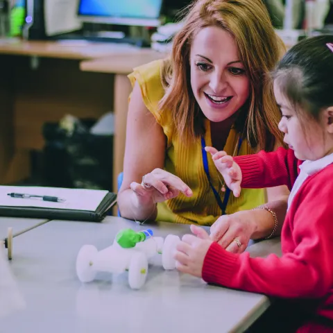 A teacher and a student in a primary school