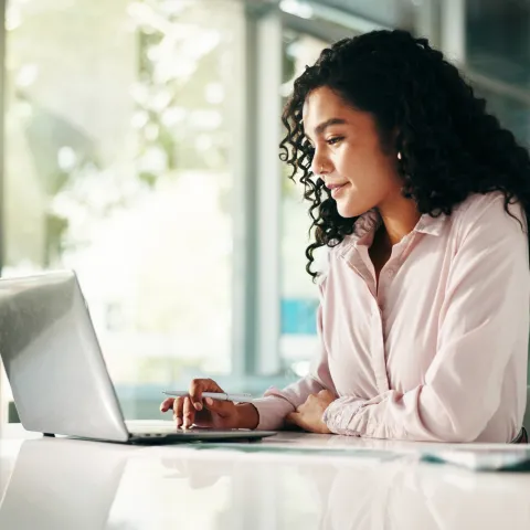 Woman sitting behind laptop