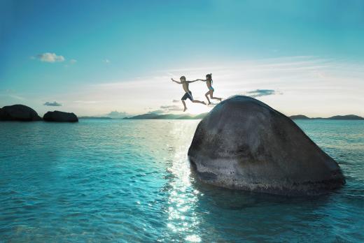 Children jumping into sea