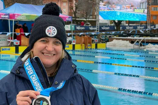 Nicola with a medal by the pool